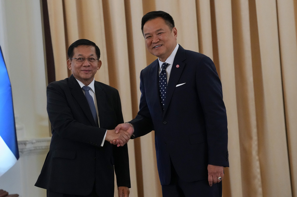 Myanmar President Min Aung Hlaing, left, shakes hands with Thailand's Prime Minister Anutin Charnvirakul at the government house in Bangkok, Thailand, Thursday, Aug. 6, 2026. (AP Photo/Sakchai Lalit)