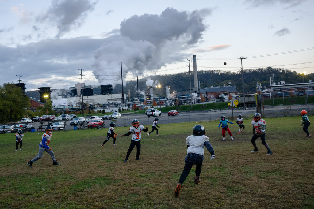 Youth football players practice near U.S. Steel's Clairton Coke Works in Clairton, Pa., on Thursday, Oct. 23, 2025. (Quinn Glabicki/Pittsburgh's Public Source via AP)