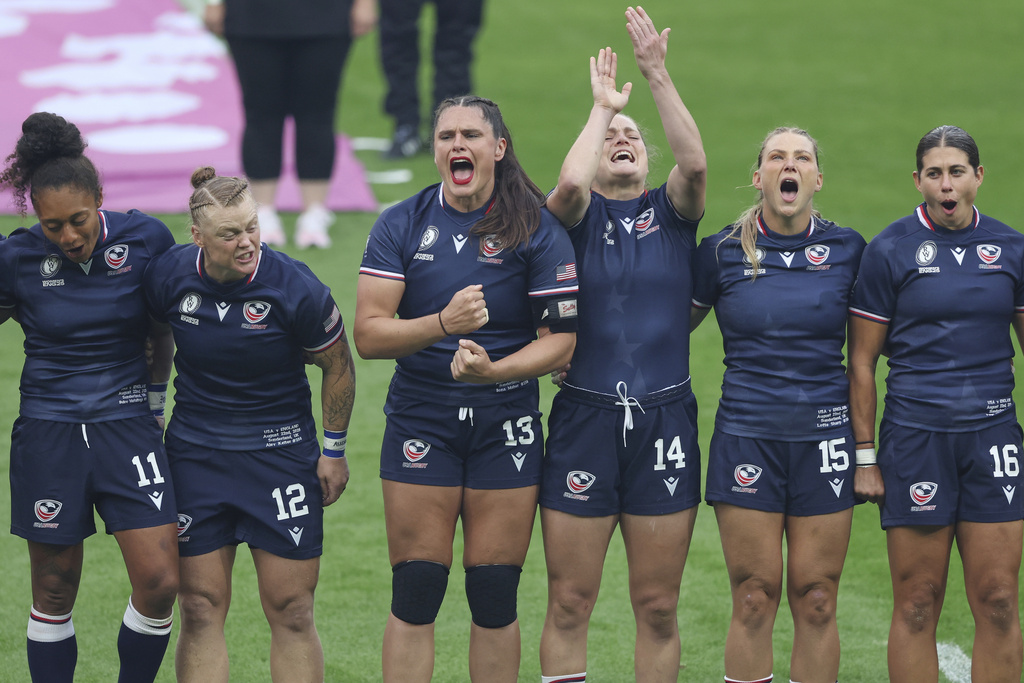The United States, including Ilona Maher of the United States, center, team lines up during the opening ceremony before the start of the group A match at the 2025 Women's Rugby World Cup between England and the United States in Sunderland, England, Friday, Aug. 22, 2025. (AP Photo/Scott Heppell)