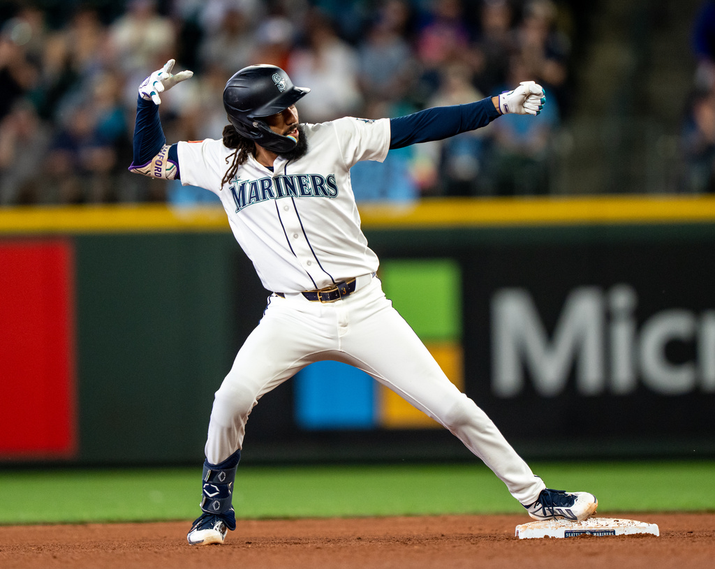 Seattle Mariners' J.P. Crawford celebrates at second base after hitting a double during the third inning of a baseball game against the New York Mets, Wednesday, June 3, 2026, in Seattle. (AP Photo/Stephen Brashear)