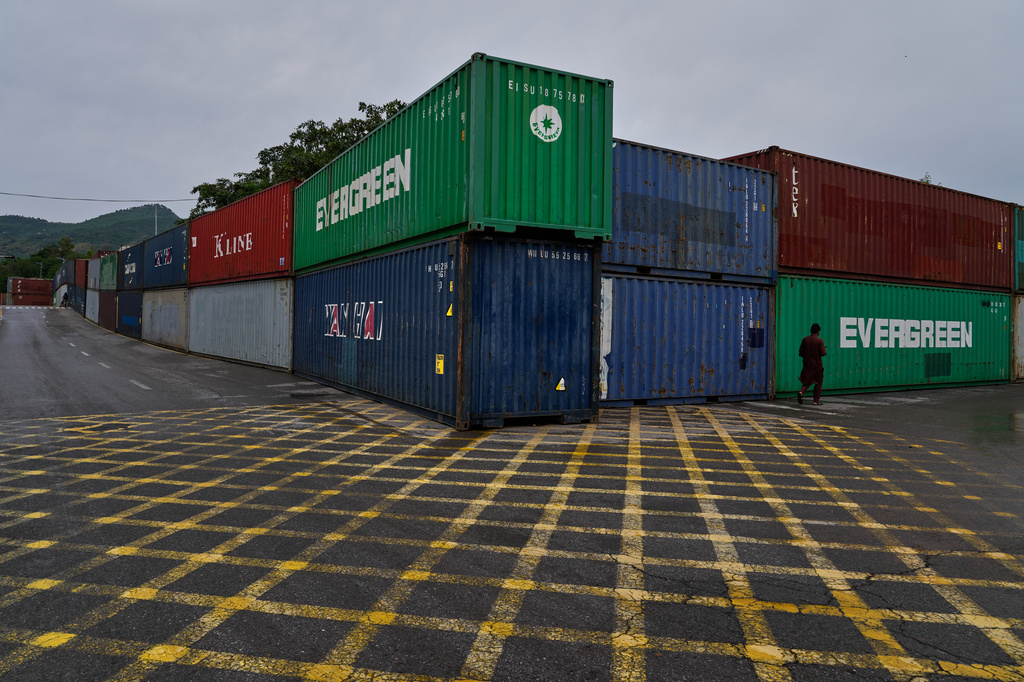 A resident walk past shipping containers placed by authorities to seal off an area ahead of a plan protest march by the supporters of imprisoned former Prime Minister Imran Khan demanding his release, in Islamabad, Pakistan, Monday, Sept. 28, 2026. (AP Photo/Anjum Naveed)