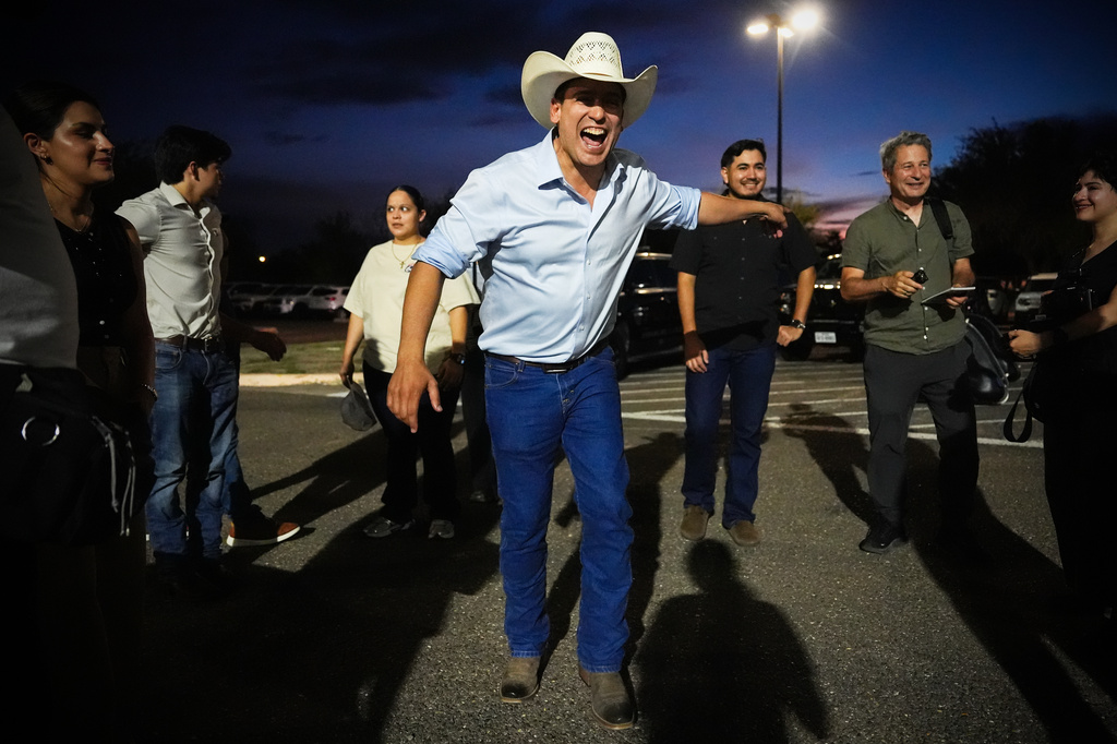 FILE - Democratic candidate for congress Bobby Pulido laughs while speaking with reporters and staff members in the parking lot of Richard R. Flores Stadium, before attending a football game between Edcouch-Elsa High School and Robert Vela High School, Thursday, Sept. 17, 2026, in Edinburg, Texas. (AP Photo/Julia Demaree Nikhinson,File)