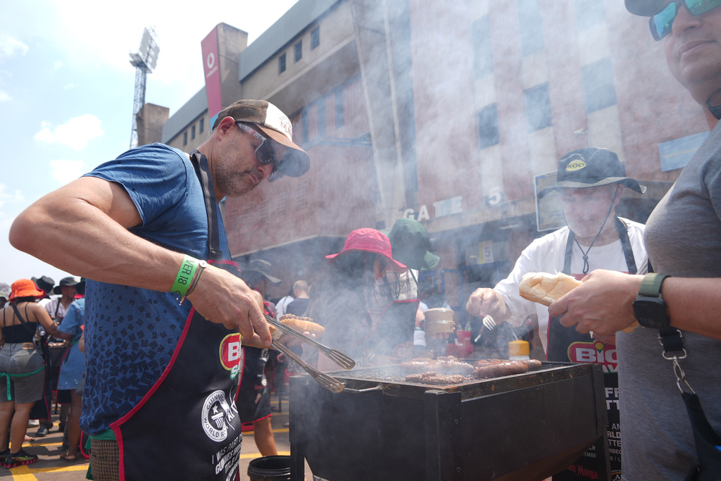 Participants grill meat during an attempt to break a world record for the most people cooking simultaneously at a barbecue at Loftus Versfeld Stadium, Pretoria, South Africa, Thursday, Sept. 24, 2026. (AP Photo/Alfonso Nqunjana)