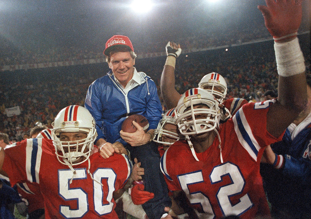 FILE - IN this Jan. 12, 1986, file photo, New England Patriots coach Raymond Berry gets a victory ride from players Larry McGrew (50) and Johnny Rembert (52) after the Patriots defeated the Miami Dolphins 31-14 in the NFL football AFC playoffs in Miami. (AP Photo/File)
