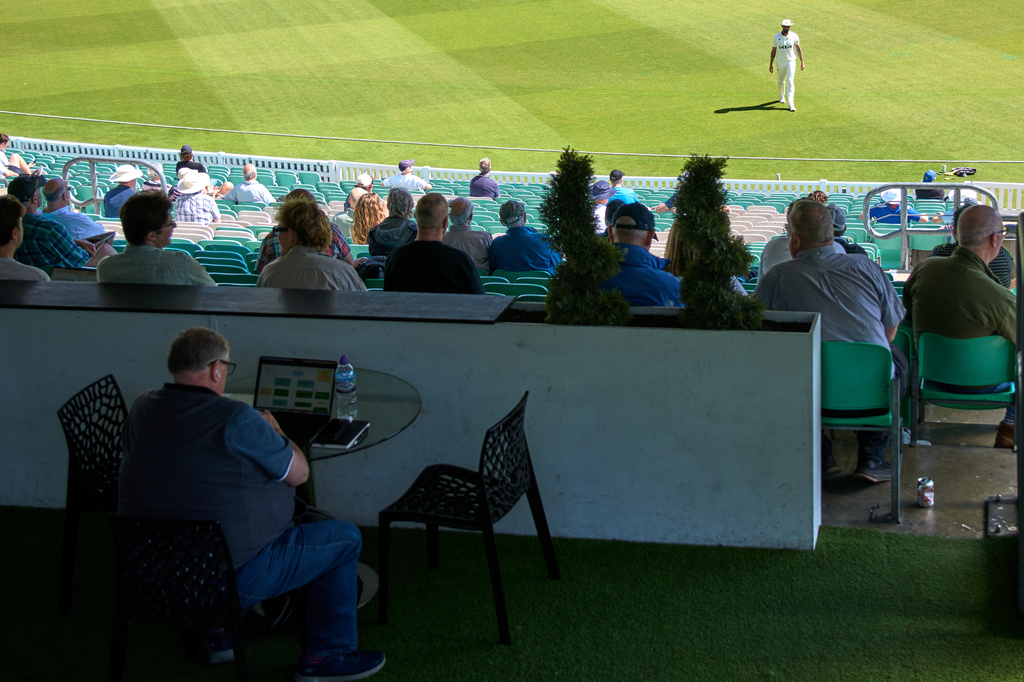 A man works during a Surrey against Sussex County Championship cricket match at the Kia Oval in London, Friday, May 1, 2026. (AP Photo/Tony Hicks)
