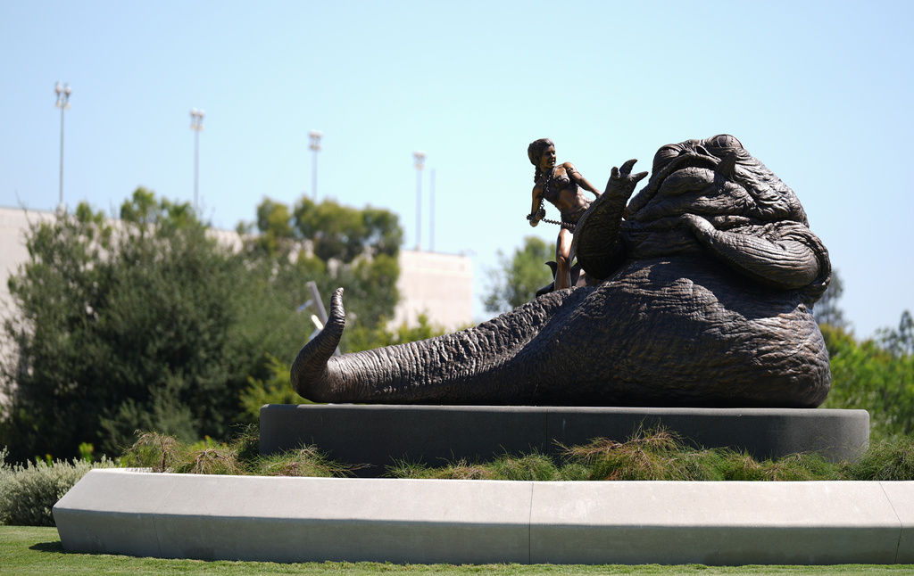A lawn sculpture featuring the "Star Wars" characters Princess Leia and Jabba The Hutt is pictured in the garden area of the Lucas Museum of Narrative Art on Monday, Aug. 31, 2026, in Los Angeles. (AP Photo/Chris Pizzello)