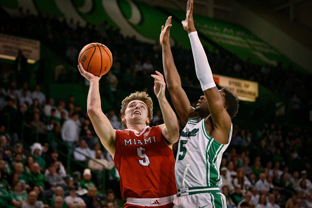 Miami (Ohio) Guard Peter Suder (5) jumps to the basket against Marshall during the second half of an NCAA college Basketball game, Saturday, Feb. 7, 2026, in Huntington, W.Va. (AP Photo/Tyler Evert)