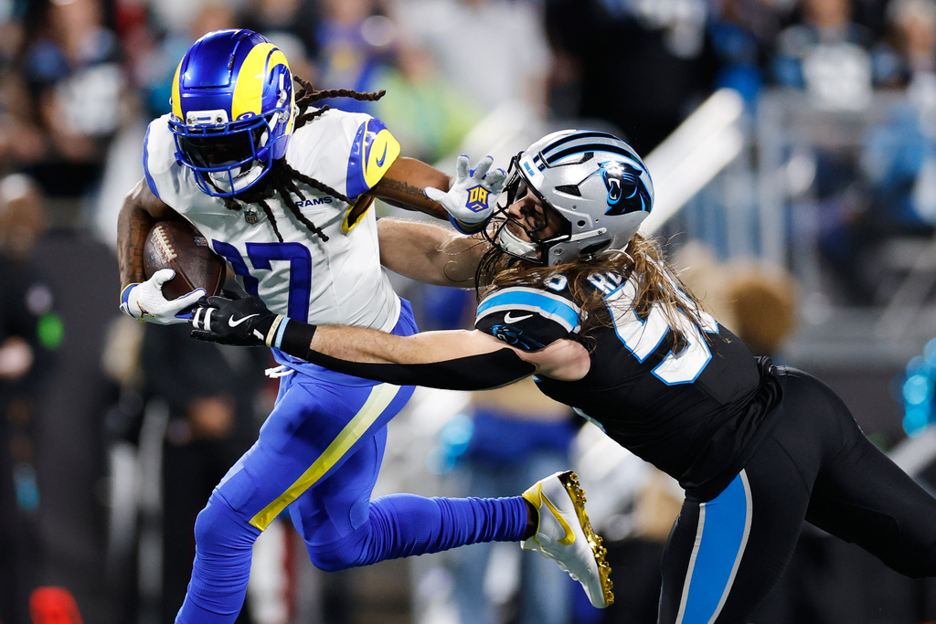 Los Angeles Rams wide receiver Davante Adams (17) is tackled by Carolina Panthers linebacker Christian Rozeboom during the second half of an NFL wild-card playoff football game, Saturday, Jan. 10, 2026, in Charlotte, N.C. (AP Photo/Rusty Jones)