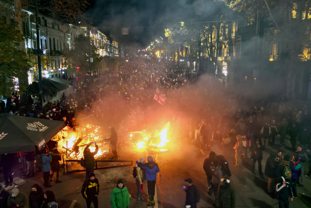 FILE - Protesters pour into the streets outside the parliament building in Tbilisi, Georgia, on Friday, Nov. 29, 2024. (AP Photo/Zurab Tsertsvadze, File)
