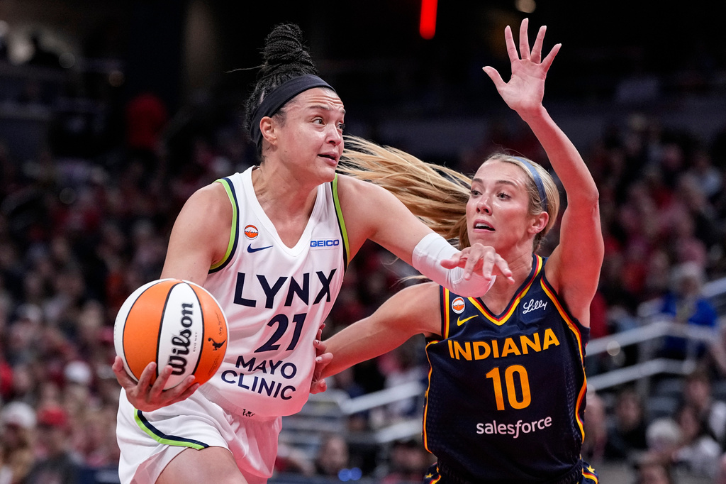 Minnesota Lynx guard Kayla McBride (21) drives on Indiana Fever guard Lexie Hull (10) in the first half of a WNBA basketball game in Indianapolis, Tuesday, Sept. 22, 2026. (AP Photo/Michael Conroy)