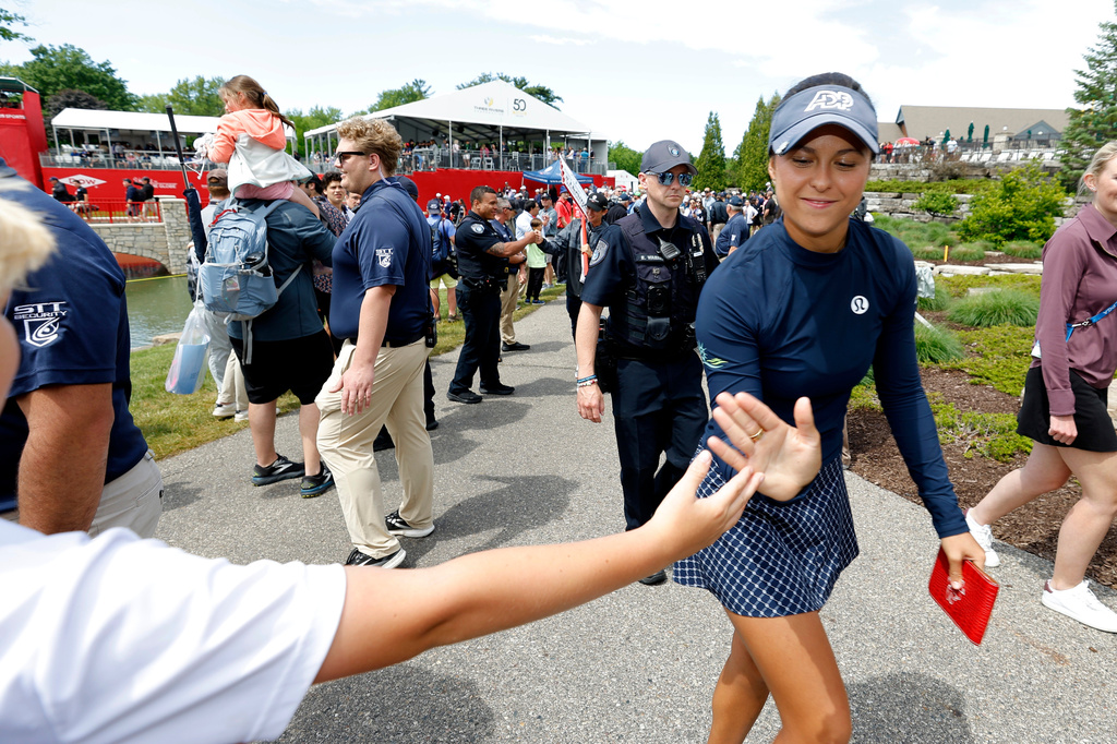 Yana Wilson greets fans as she walks to the clubhouse after finishing the final round of the Dow Championship LPGA golf tournament, Sunday, June 14, 2026, at Midland Country Club in Midland, Mich. (AP Photo/Al Goldis)