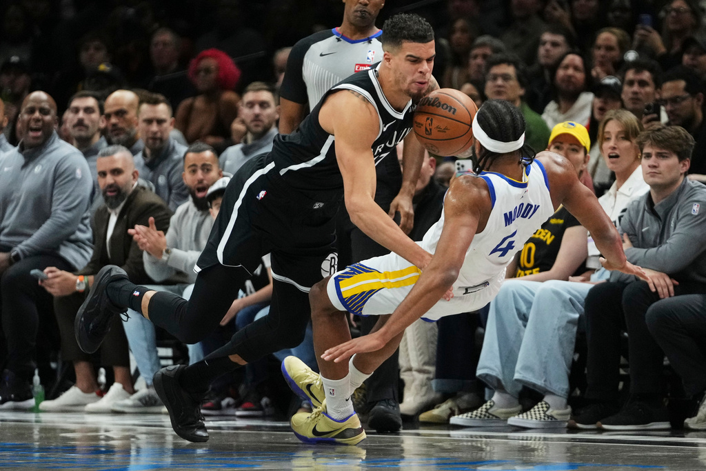Brooklyn Nets' Michael Porter Jr. (17) collides with Golden State Warriors' Moses Moody (4) during the first half of an NBA basketball game Monday, Dec. 29, 2025, in New York. (AP Photo/Frank Franklin II)