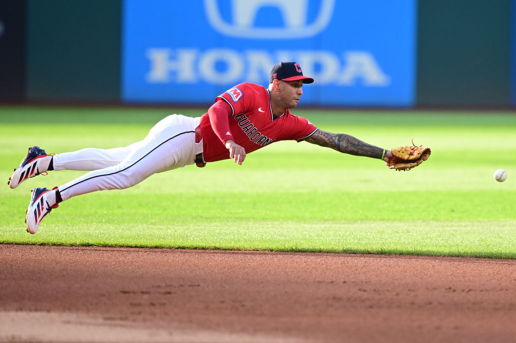 Cleveland Guardians shortstop Brayan Rocchio dives in an attempt to field a ball hit by San Francisco Giants' Jonah Cox during the first inning of a baseball game, Tuesday, Aug. 18, 2026, in Cleveland. (AP Photo/David Dermer)