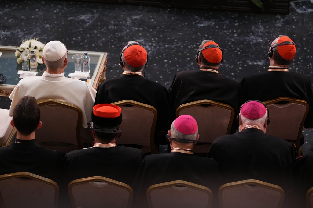 Pope Leo XIV listens to Turkish President Recep Tayyip Erdogan's speech as he meets with authorities, members of the civil society and diplomats in the Presidential Palace's national library, in Ankara, Turkey, Thursday, Nov. 27, 2025. (AP Photo/Domenico Stinellis)