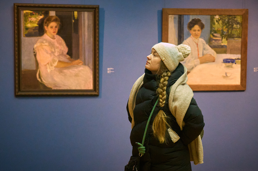 A visitor at Ukraine's National Art Museum is bundled up due to power outages caused by Russian air attacks on the country's energy system, affecting the museum's temperature during winter in Kyiv, Ukraine, on Feb. 6, 2026. (AP Photo/Efrem Lukatsky)