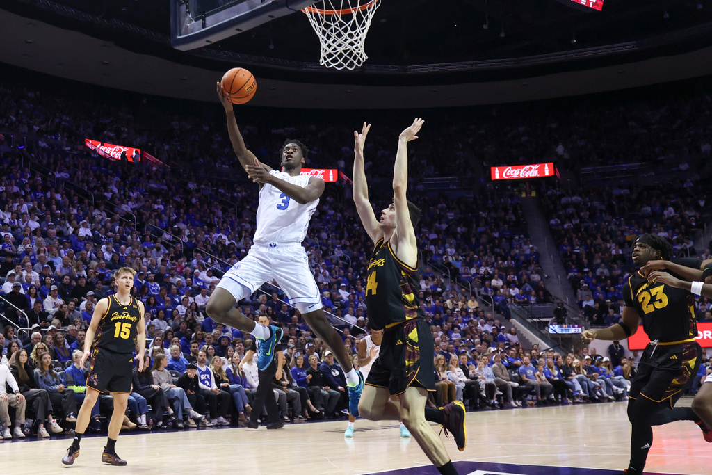 BYU forward AJ Dybantsa (3) goes for a layup against Arizona State forward Andrija Grbovic (14) during the first half of an NCAA basketball game, Wednesday, Jan. 7, 2026, in Provo, Utah. (AP Photo/Rob Gray)