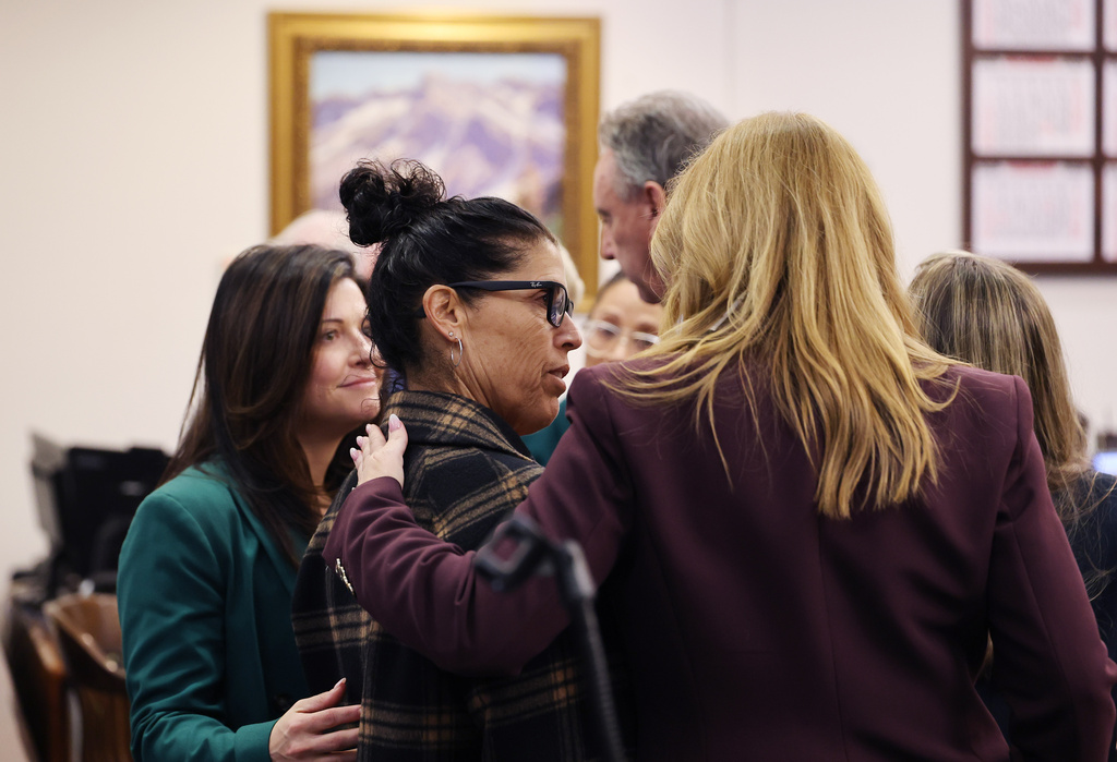 Tyler Skaggs mother, Debbie Skaggs, center, gets a hug in court after a settlement was reached in the wrongful death lawsuit by the family of pitcher Tyler Skaggs against the Los Angeles Angels in Orange County Superior Court in Santa Ana, Calif., Friday, Dec. 19, 2025. (Allen J. Schaben/Los Angeles Times via AP, Pool)