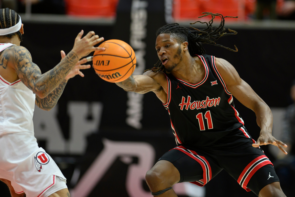 Houston forward Joseph Tugler, right, steals the ball away from Utah guard Terrence Brown, left, during the second half of an NCAA college basketball game, Tuesday, Feb. 10, 2026, in Salt Lake City. (AP Photo/Tyler Tate)