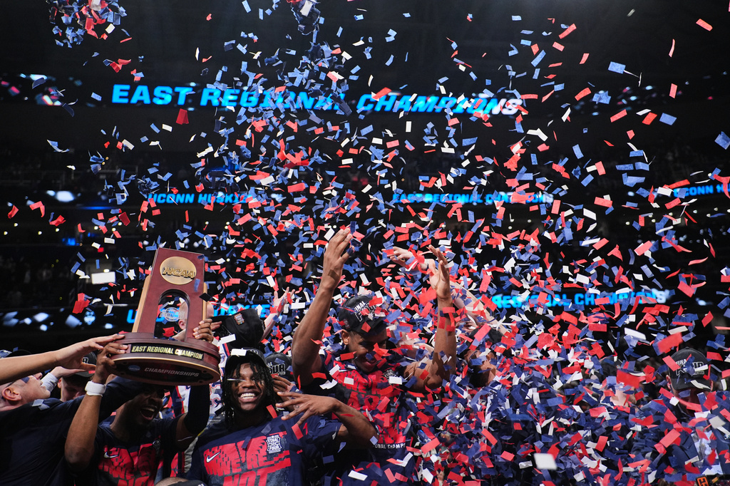 UConn players celebrate after their win against Duke in the Elite Eight of the NCAA college basketball tournament, Sunday, March 29, 2026, in Washington. (AP Photo/Abbie Parr)