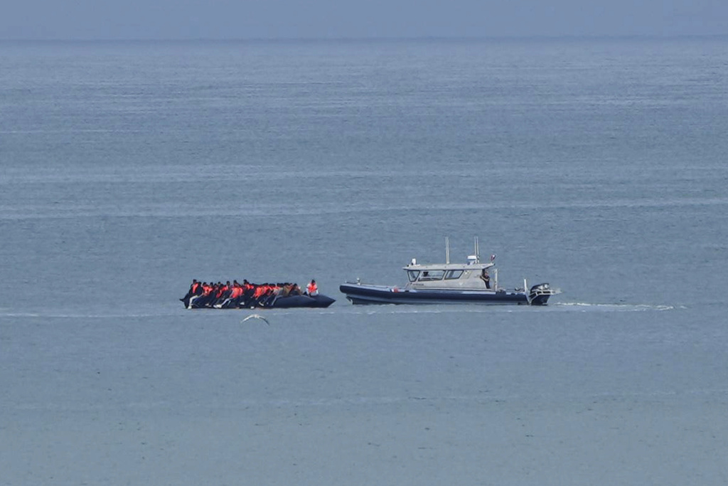FILE - A boat thought to carry migrants is escorted by a vessel from the French Gendarmerie Nationale in the English Channel off Wimereux beach, France, Wednesday, Sept. 4, 2024. (AP Photo/Nicolas Garriga, File)