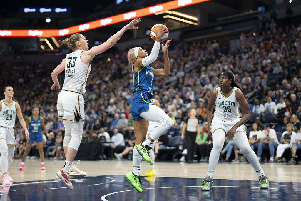Minnesota Lynx guard DiJonai Carrington (3) attempts a layup while being defended by New York Liberty center Emma Meesseman (33) during the first half of an WNBA basketball game in Minneapolis, Minn., Saturday, Aug. 16, 2025. (Alex Kormann/Star Tribune via AP)
