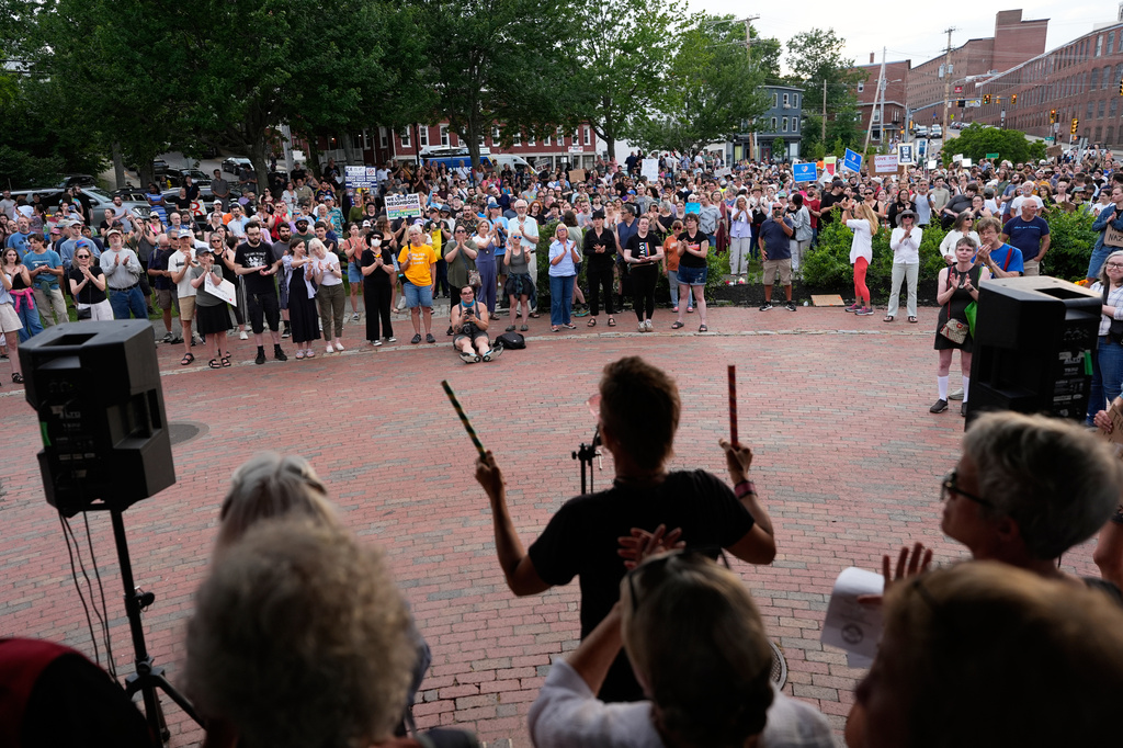 Attendees stand during a vigil after a man was shot and killed by U.S. Immigration and Customs Enforcement on Monday, July 13, 2026, in Biddeford, Maine. (AP Photo/Robert F. Bukaty)