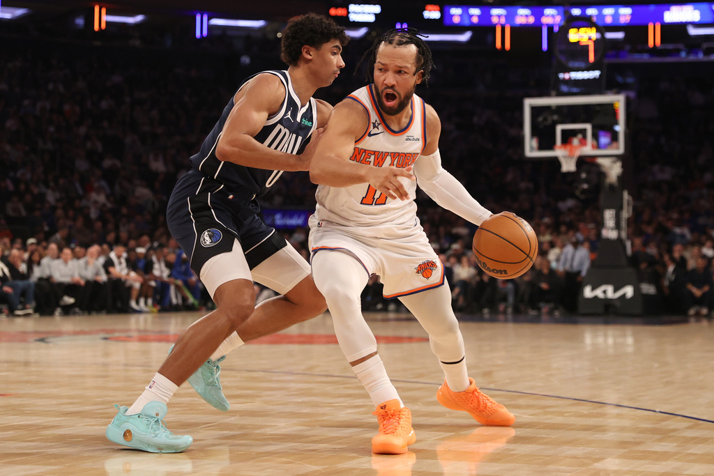 New York Knicks' Jalen Brunson, right, dribbles against Dallas Mavericks' Max Christie, left, during the first half of an NBA basketball game, Monday, Jan. 19, 2026, in New York. (AP Photo/Pamela Smith)