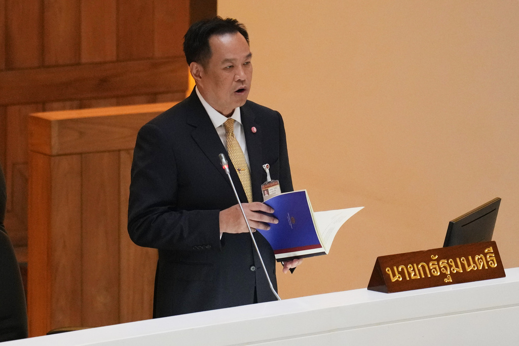 Thailand's Prime Minister Anutin Charnvirakul reads the policy statement at the parliament in Bangkok, Thailand, Monday, Sept. 29, 2025. (AP Photo/Sakchai Lalit)