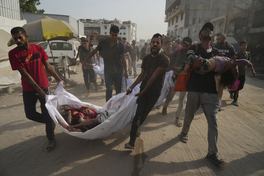 The bodies of Palestinians killed by an Israeli airstrike are brought to Shifa Hospital in Gaza City Monday, Aug. 11, 2025. (AP Photo/Jehad Alshrafi)