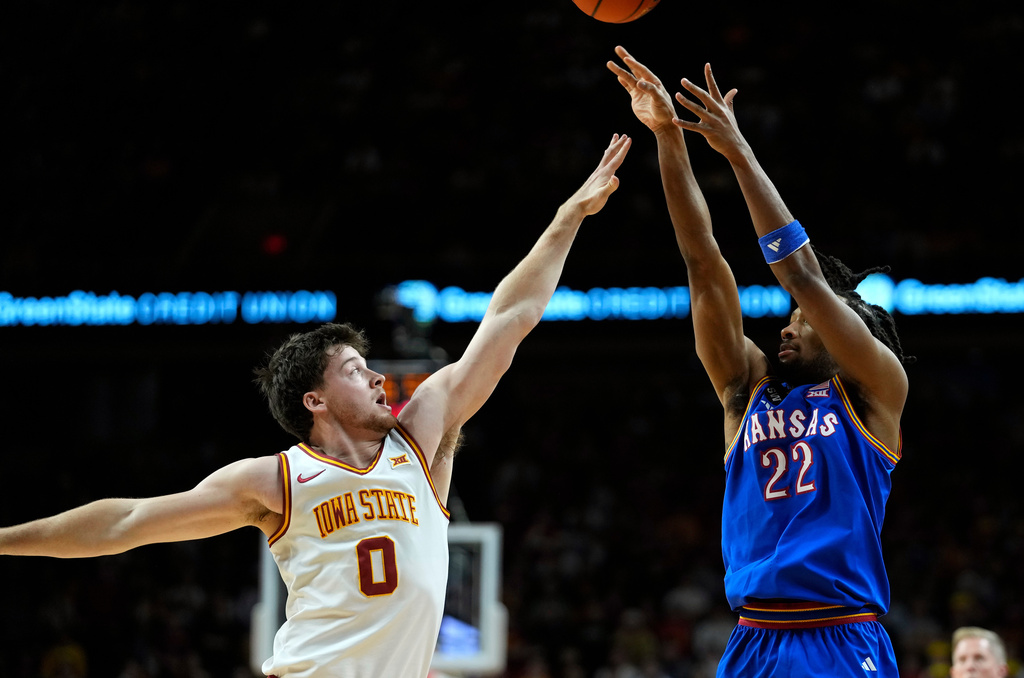 Kansas guard Darryn Peterson (22) shoots over Iowa State guard Nate Heise (0) during the first half of an NCAA college basketball game, Saturday, Feb. 14, 2026, in Ames, Iowa. (AP Photo/Matthew Putney)
