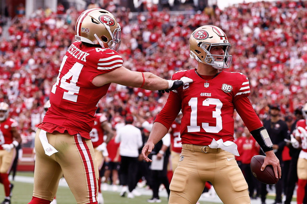 San Francisco 49ers quarterback Brock Purdy (13) is congratulated by fullback Kyle Juszczyk (44) after scoring against the Miami Dolphins during the first half of an NFL football game in Santa Clara, Calif., Sunday, Sept. 20, 2026. (AP Photo/Kelley L. Cox)