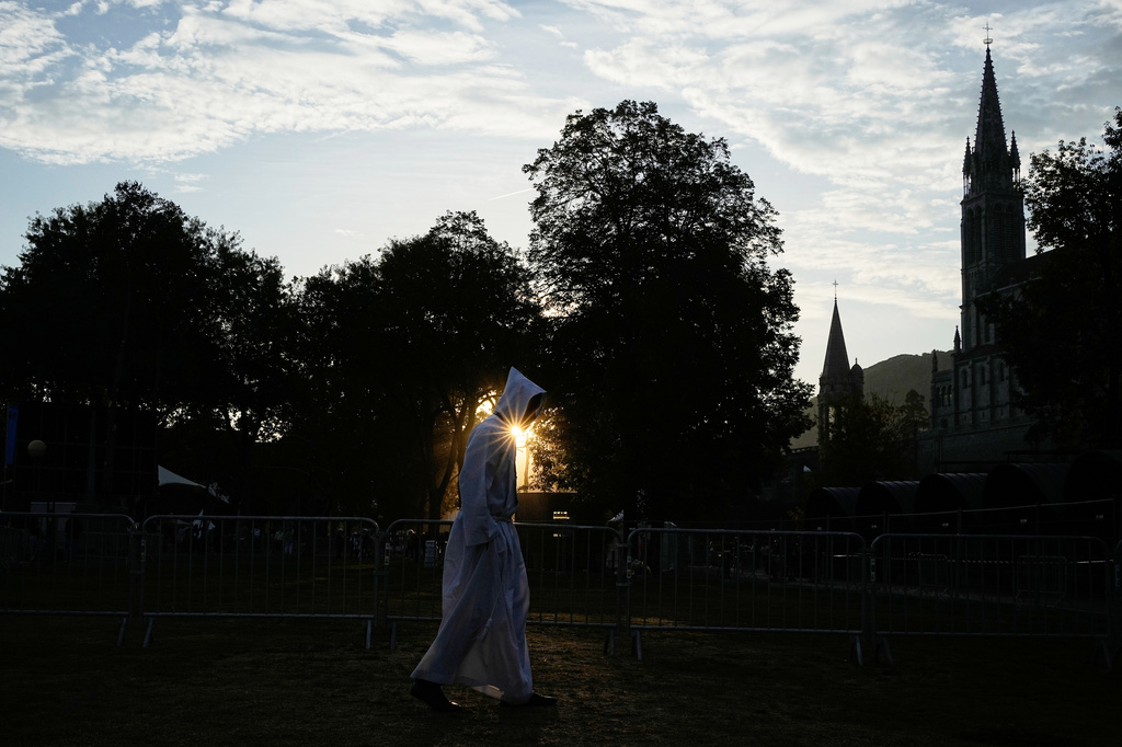 A priest arrives for a Mass celebrated by Pope Leo XIV at the Sanctuary of Our Lady of Lourdes, Sunday, Sept. 27, 2026. (AP Photo/Laurent Cipriani)