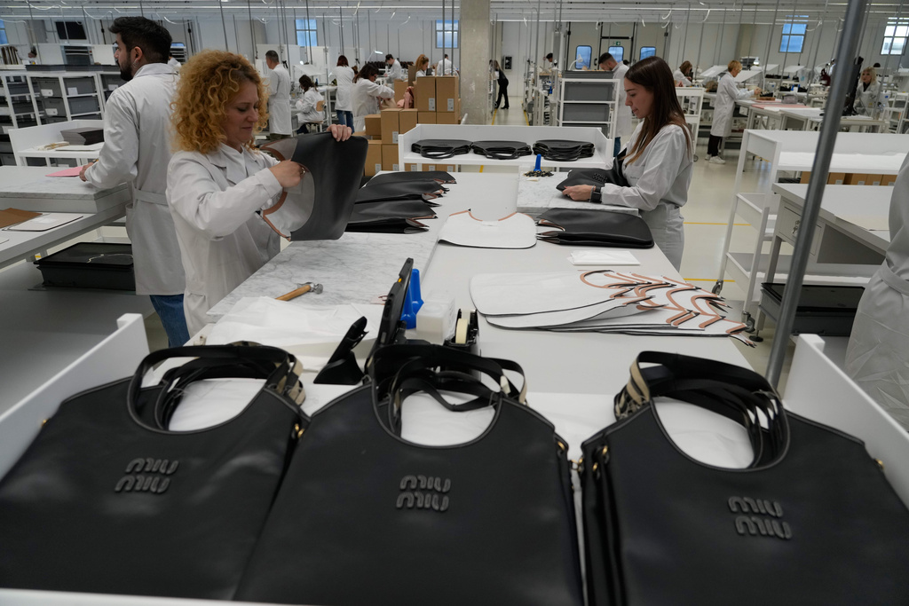 Leather good operators work at the Prada factory in Scandicci, Italy, Friday, Nov. 28, 2025. (AP Photo/Gregorio Borgia)