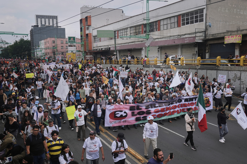 Demonstrators march during a protest commemorating the anniversary of the 1968 Tlatelolco killings, when soldiers fired on student protesters, in Mexico City, Thursday, Oct. 2, 2025. (AP Photo/Claudia Rosel)