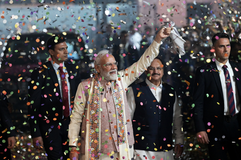 Indian Prime Minister Narendra Modi is showered with confetti on his arrival at the headquarters of the Bhartiya Janata Party in New Delhi after the National Democratic Alliance led by his party headed toward a landslide victory in the eastern state of Bihar, India, Friday, Nov. 14, 2025. (AP Photo)