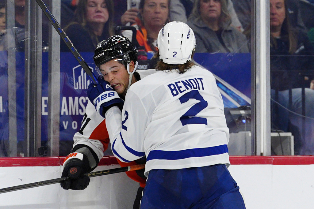 Toronto Maple Leafs' Simon Benoit (2) checks Philadelphia Flyers' Tyson Foerster during the second period of an NHL hockey game Saturday, Nov. 1, 2025, in Philadelphia. (AP Photo/Derik Hamilton)