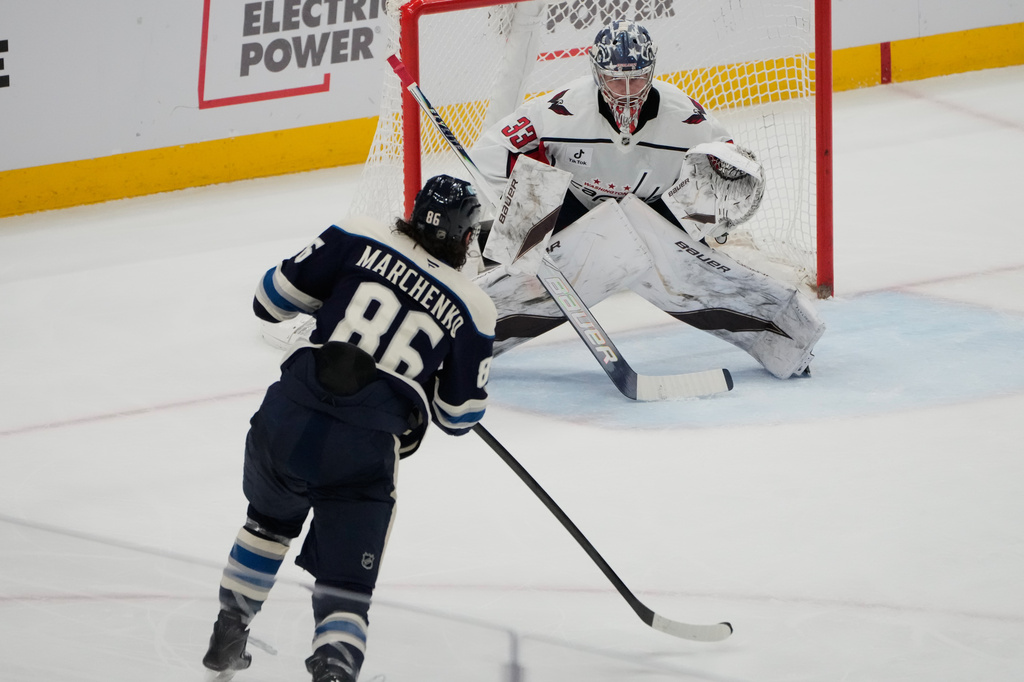 Columbus Blue Jackets right wing Kirill Marchenko (86) skates in on Washington Capitals goaltender Clay Stevenson (33) in the second period of an NHL hockey game Tuesday, April 14, 2026, in Columbus, Ohio. (AP Photo/Sue Ogrocki)