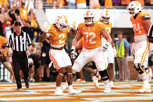 Tennessee running back Peyton Lewis (2) celebrates with offensive lineman Shamurad Umarov (74) and Jesse Perry after scoring a touchdown during the second half of an NCAA college football game against Arkansas, Saturday, Oct. 11, 2025, in Knoxville, Tenn. (AP Photo/Wade Payne) Tennessee running back Peyton Lewis (2) celebrates with offensive lineman Shamurad Umarov (74) and Jesse Perry after scoring a touchdown during the second half of an NCAA college football game against Arkansas, Saturday, Oct. 11, 2025, in Knoxville, Tenn. (AP Photo/Wade Payne)