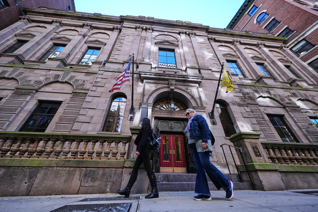 Two pedestrians walk past the Boston Athenaeum, one of the oldest independent libraries in the United States, Thursday, Oct. 9, 2025, in Boston. (AP Photo/Charles Krupa)