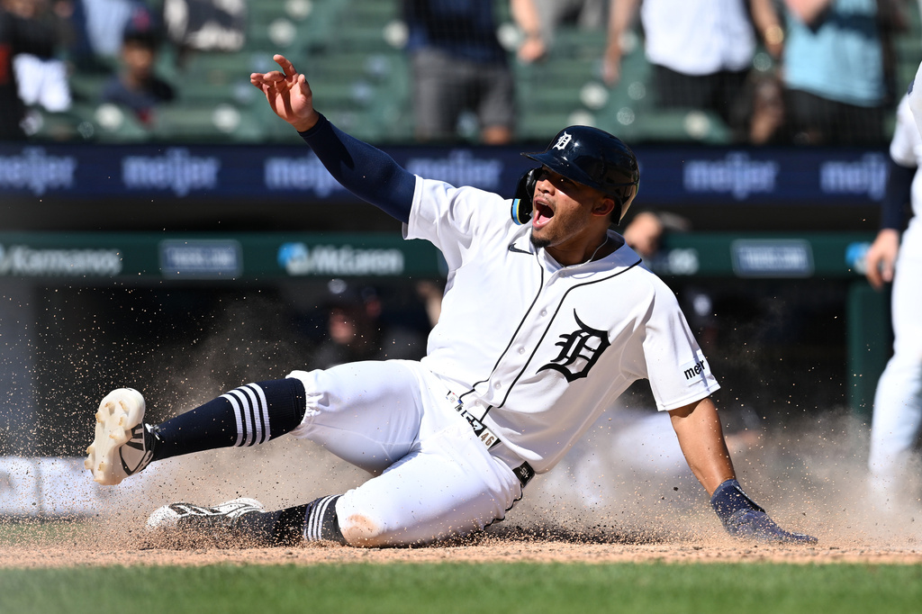 Detroit Tigers' Wenceel Pérez celebrates as he slides across home plate with the game-winning run against the Seattle Mariners in the ninth inning of a baseball game, Sunday, June 7, 2026, in Detroit. (AP Photo/Lon Horwedel)