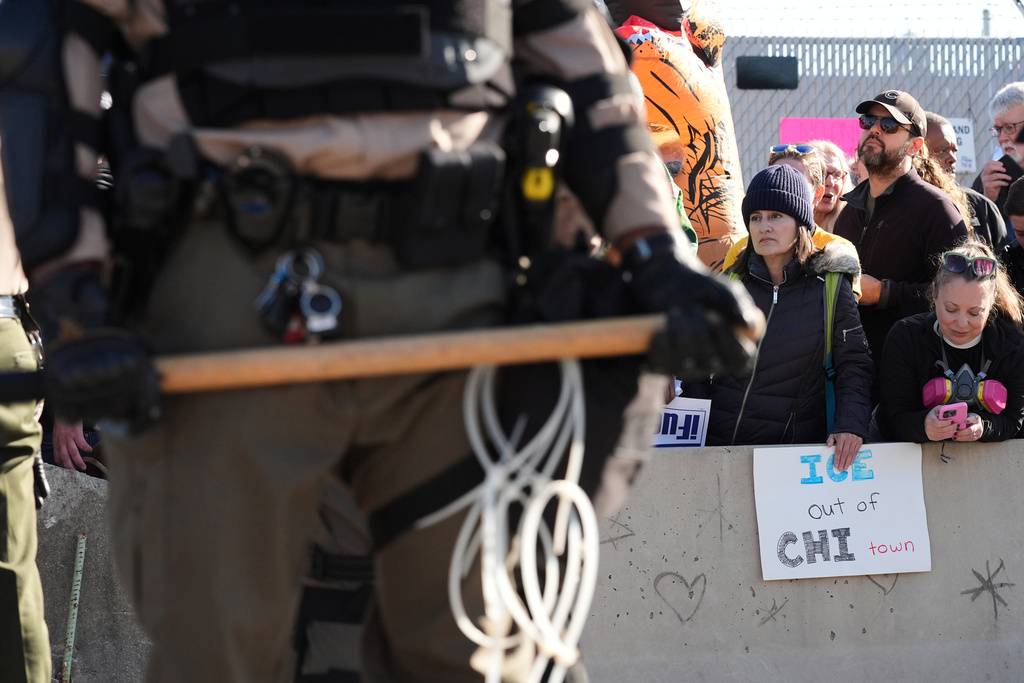 Illinois State Police and Cook County Sheriff Police guard as protesters gather outside an ICE processing facility in the Chicago suburb of Broadview, Ill., Friday, Nov. 14, 2025. (AP Photo/Nam Y. Huh)