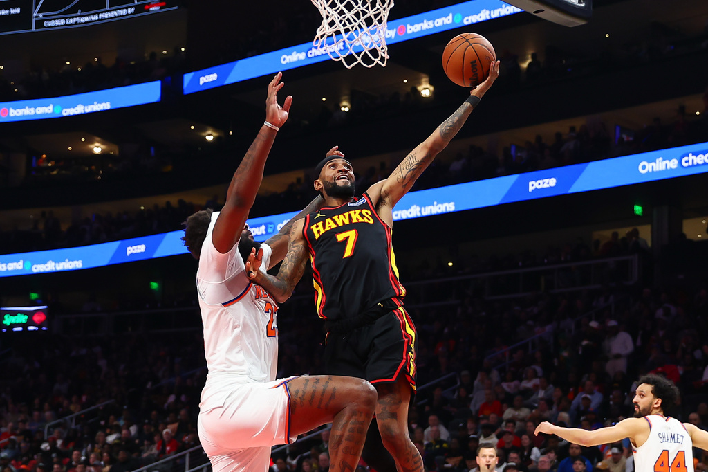 Atlanta Hawks guard Nickeil Alexander-Walker (7) shoots against New York Knicks center Mitchell Robinson, left, during the first half of an NBA basketball game, Monday, April. 6, 2026, in Atlanta. (AP Photo/Colin Hubbard)