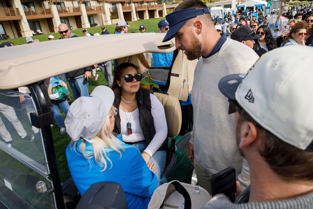 Travis Kelce of the Kansas City Chiefs checks on Edenne Flinn — who was hit in the head by Kelce's golf ball during play — on the 18th hole in the second round of the AT&T Pebble Beach Pro-Am in Pebble Beach, Calif., on Friday, Feb. 13, 2026. (Santiago Mejia/San Francisco Chronicle via AP)