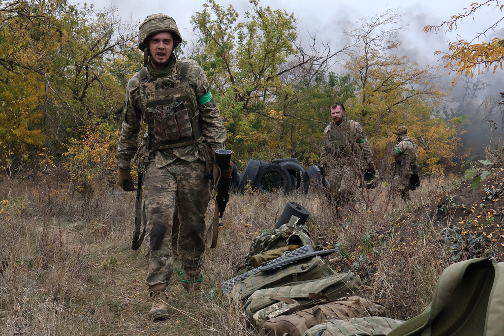 In this photo provided by Ukraine's 65th Mechanized Brigade press service, recruits attend drills at a training ground in the Zaporizhzhia region, Ukraine, Saturday, Oct. 11, 2025. (Andriy Andriyenko/Ukraine's 65th Mechanized Brigade via AP)