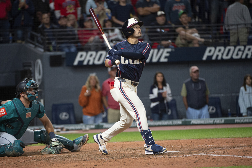 Cleveland Guardians' Steven Kwan, right, watches his winning sacrifice fly off Seattle Mariners' Andres Munoz as Mariners catcher Cal Raleigh, left, looks on during the ninth inning of a baseball game, Friday, Aug. 29, 2025, in Cleveland. (AP Photo/Phil Long)