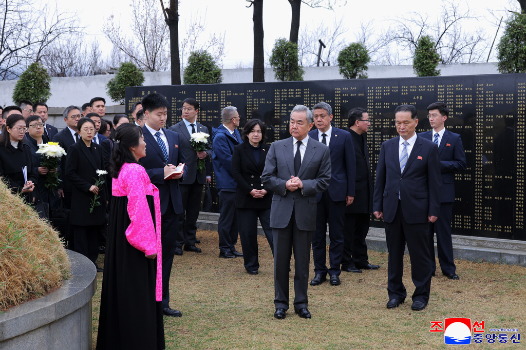 In this photo provided by the North Korean government, Chinese Foreign Minister Wang Yi, center, visits a memorial cemetery for Chinese soldiers who participated in Korean War, on the outskirts of Pyongyang, North Korea, Friday, April 10, 2026. Independent journalists were not given access to cover the event depicted in this image distributed by the North Korean government. The content of this image is as provided and cannot be independently verified. Korean language watermark on image as provided by source reads: "KCNA" which is the abbreviation for Korean Central News Agency. (Korean Central News Agency/Korea News Service via AP)