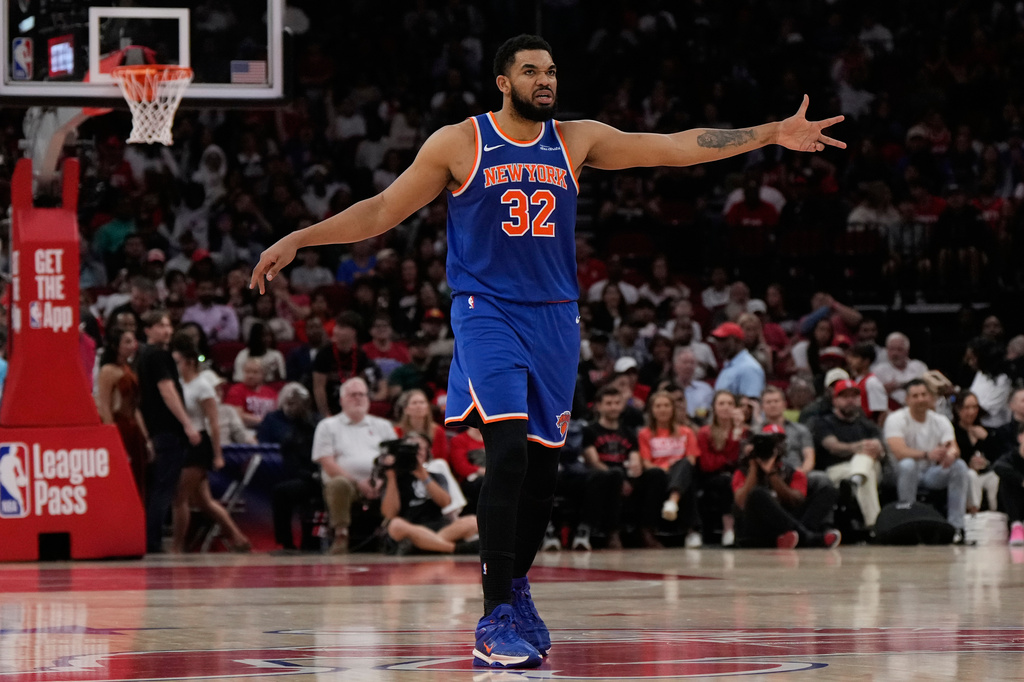 New York Knicks center Karl-Anthony Towns celebrates after a 3-pointer during the first half of an NBA basketball game against the Houston Rockets in Houston, Tuesday, March 31, 2026. (AP Photo/Ashley Landis)