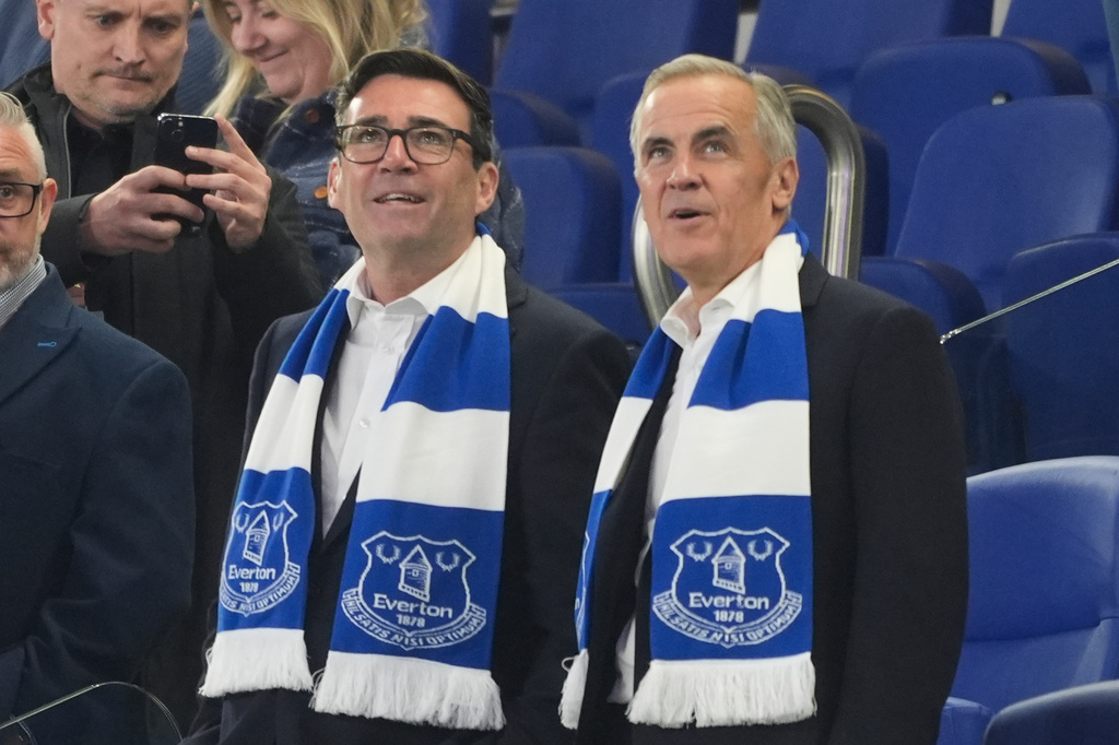 Britain's Prime Minister Andy Burnham, left, and Canada's Prime Minister Mark Carney attend the League Cup third round round soccer match between Everton and Wolverhampton Wanderers, Wednesday, Sept. 16, 2026, in Liverpool, England. (Peter Byrne/PA via AP)