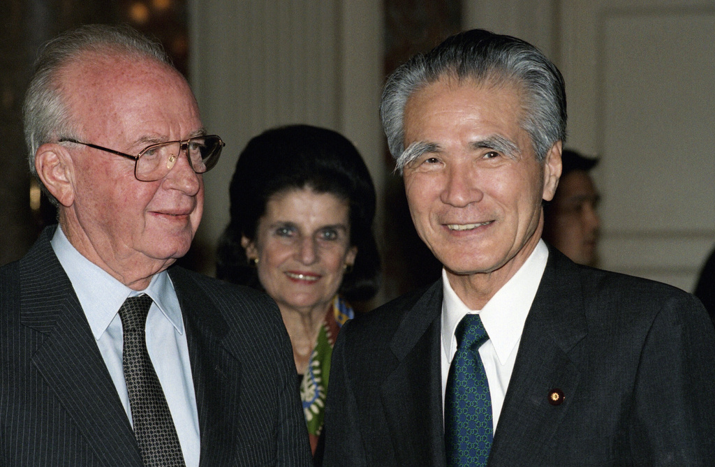 FILE - Israeli Prime Minister Yitzhak Rabin, left, with first lady Leah Rabin, shares a smile with Japanese counterpart Tomiichi Murayama upon his arrival for a welcome ceremony for him on Dec. 12, 1994, at the Akasaka state guest house in Tokyo. (AP Photo/Tsugufumi Matsumoto, Pool, File)