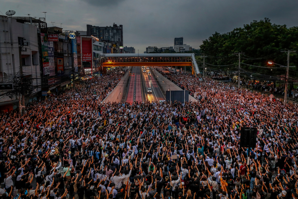 FILE - Pro-democracy activists flash three-fingered salutes during a demonstration at Kaset intersection, suburbs of Bangkok, Thailand, on Oct. 19, 2020. (AP Photo/Sakchai Lalit, File)